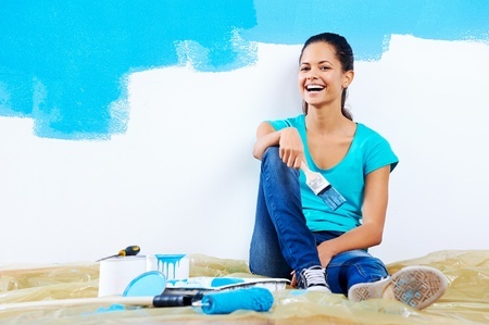 young woman painting her new home