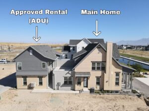 Aerial view of a property with two labeled sections: "Approved Rental (ADU)" and "Main Home," featuring a main house and an additional smaller unit.